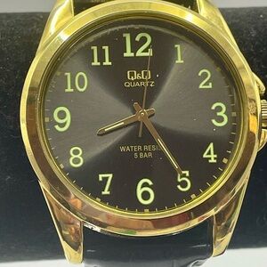 Q & Q Quartz Watch Water Resistant. Gold Case, Black Dial and Leather Look Band